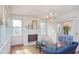 Bright living room showcasing a charming fireplace, hardwood floors, and an open doorway at 1019 Prince St., Georgetown, SC 29440