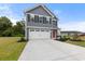 Charming two-story home featuring a spacious two-car garage, red door, and manicured lawn at 1108 Oak Meadow Dr., Conway, SC 29526