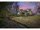 Backyard with a rock-lined creek, trees, landscaping, and a partial fence at 120 Swallowtail Ct., Little River, SC 29566