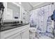 Updated bathroom features a nautical-themed shower curtain and an elegant vanity with sink at 120 Swallowtail Ct., Little River, SC 29566