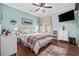 Bedroom with ceiling fan, hardwood floors, window, TV, lamps and two bedside tables at 120 Swallowtail Ct., Little River, SC 29566