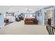Large bonus room/bedroom with comfortable seating, light blue walls, and ensuite bathroom access at 120 Swallowtail Ct., Little River, SC 29566