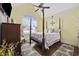 Bedroom with vaulted ceiling, four-poster bed, beautiful curtains, wood floors and large windows at 120 Swallowtail Ct., Little River, SC 29566