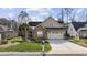 Charming home featuring a stone facade, well-manicured lawn, and a two-car garage in a desirable neighborhood at 120 Swallowtail Ct., Little River, SC 29566