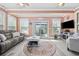 Cozy sunroom featuring a neutral palette, ceiling fans, and sliding glass doors to outdoor seating at 120 Swallowtail Ct., Little River, SC 29566