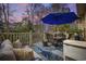 Outdoor patio featuring a dining table with umbrella and comfortable seating for outdoor relaxation during sunset at 120 Swallowtail Ct., Little River, SC 29566