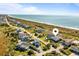 Aerial view of coastal home near the beach, showcasing the neighborhood, ocean views, and easy beach access at 1257 Ocean Blvd., Holden Beach, NC 28462