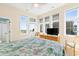 Sunny bedroom with multiple windows offering ocean views and a door to the balcony at 1257 Ocean Blvd., Holden Beach, NC 28462