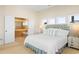 Comfortable bedroom boasts ensuite bathroom access, soft lighting, and multiple windows offering tranquil views at 1257 Ocean Blvd., Holden Beach, NC 28462