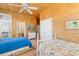 Bright bedroom with wood paneled walls, ceiling fan and ensuite bathroom at 1257 Ocean Blvd., Holden Beach, NC 28462