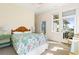 Bright bedroom with ensuite bathroom, ceiling fan and balcony access offering lovely beach views at 1257 Ocean Blvd., Holden Beach, NC 28462