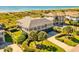 Stunning beach house with manicured lawn, palm trees, and views of the ocean and beach access at 1257 Ocean Blvd., Holden Beach, NC 28462