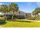 Beautifully landscaped exterior featuring palm trees and a well-maintained yard at 1257 Ocean Blvd., Holden Beach, NC 28462