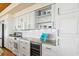 This kitchen has white cabinets, granite counters, modern appliances, open shelving and wine storage at 1257 Ocean Blvd., Holden Beach, NC 28462