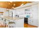 This spacious kitchen has white cabinets, granite counters, modern appliances, and wine storage at 1257 Ocean Blvd., Holden Beach, NC 28462