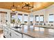 Enjoy an expansive kitchen with an island, wood ceiling, and ocean views from the large windows at 1257 Ocean Blvd., Holden Beach, NC 28462
