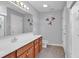 This bathroom features wood cabinets, a walk in shower, and tile floors at 1336 Gailard Dr., Conway, SC 29526
