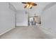 Bright living room with neutral carpet, ceiling fan, and open access to the dining area, perfect for entertaining at 1336 Gailard Dr., Conway, SC 29526