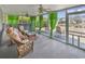 Relaxing screened porch area features comfortable seating and views of the backyard pond at 1336 Gailard Dr., Conway, SC 29526