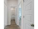 Hallway view of a bathroom and bedroom. The space boasts hardwood floors and white doors at 1356 Palm Springs Paloma Dr, Longs, SC 29568