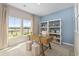 Bright home office with large windows, desk, and bookcase at 1356 Palm Springs Paloma Dr, Longs, SC 29568