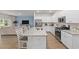 Modern kitchen featuring white cabinets, granite countertops, and stainless steel appliances at 1356 Palm Springs Paloma Dr, Longs, SC 29568