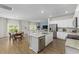 Open concept kitchen with island, stainless steel appliances, and adjacent living area at 1356 Palm Springs Paloma Dr, Longs, SC 29568