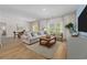 Inviting living room with comfortable seating, natural light, and dining area at 1356 Palm Springs Paloma Dr, Longs, SC 29568