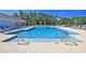 Inviting community pool with lounge chairs and plenty of space for relaxation at 1356 Palm Springs Paloma Dr, Longs, SC 29568