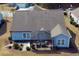 Aerial shot features a home with screened in patio overlooking a manicured lawn and adjacent to mature trees at 1439 Castleberry Pl., Myrtle Beach, SC 29588