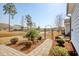 Landscaped backyard features a scenic pond view, a charming arched entry, and lush greenery at 1439 Castleberry Pl., Myrtle Beach, SC 29588