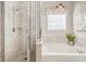 Relaxing bathroom showcases a separate shower, soaking tub, chandelier, and serene decor for a tranquil retreat at 1439 Castleberry Pl., Myrtle Beach, SC 29588