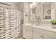 Nautical themed bathroom with dual mirrors, bright lighting, white cabinets, and decorative shower curtain at 1439 Castleberry Pl., Myrtle Beach, SC 29588