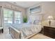 Bright bedroom featuring a large bed with blue seashell bedding and a window letting in natural light at 1439 Castleberry Pl., Myrtle Beach, SC 29588