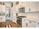 Well-lit kitchen with stainless steel appliances, white subway tile backsplash, and view into a dining room at 1439 Castleberry Pl., Myrtle Beach, SC 29588