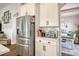 Bright kitchen featuring stainless steel appliances and white cabinets, complemented by an arched entryway to the dining area at 1439 Castleberry Pl., Myrtle Beach, SC 29588