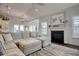 Open-concept living room with a fireplace, chandelier, and access to the kitchen, perfect for entertaining and relaxation at 1439 Castleberry Pl., Myrtle Beach, SC 29588