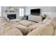 Cozy living room featuring a fireplace, large TV, and sectional sofa, creating a welcoming and comfortable space at 1439 Castleberry Pl., Myrtle Beach, SC 29588