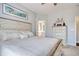 A bright main bedroom with white bed set and a dresser at 1439 Castleberry Pl., Myrtle Beach, SC 29588