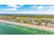 Stunning aerial view of condos along a picturesque coastline with lush greenery and calm ocean waters at 145 South Dunes Dr. # 503, Pawleys Island, SC 29585