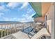 Outdoor seating and lounge furniture on a covered balcony with ocean views at 145 South Dunes Dr. # 503, Pawleys Island, SC 29585