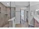 Bathroom with glass-enclosed shower, neutral tiles, and vanity with storage at 145 South Dunes Dr. # 503, Pawleys Island, SC 29585