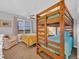 Cozy bedroom with bunk beds and queen bed providing ample sleeping arrangements and natural light at 145 South Dunes Dr. # 503, Pawleys Island, SC 29585