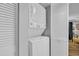 Efficient laundry area featuring a stacked washer and dryer unit at 145 South Dunes Dr. # 503, Pawleys Island, SC 29585