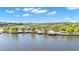 Scenic waterfront view with docks, palm trees, and lush vegetation along a calm waterway at 145 South Dunes Dr. # 503, Pawleys Island, SC 29585