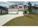 Charming two-story home boasts a manicured lawn, a two-car garage, and beautiful craftsman-style architecture at 152 Azure Loop, Myrtle Beach, SC 29588