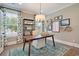 Bright home office features hardwood floors, a patterned rug, modern furnishings and ample natural light at 152 Azure Loop, Myrtle Beach, SC 29588