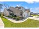 Charming townhouse boasts a well-maintained lawn, lush landscaping, and attached garages at 1586 Jardine Loop, Little River, SC 29566