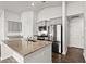Bright, modern kitchen featuring an island with granite countertops and stainless steel appliances at 1586 Jardine Loop, Little River, SC 29566