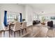 Open-concept living and dining area with hardwood floors, modern décor and ample natural light at 1586 Jardine Loop, Little River, SC 29566